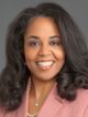 a headshot image of Dr. Amy McMichael from the neck up. She is weating a blush pink blazer and is smiling directly at camera