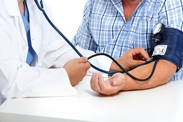 Doctor taking patient's blood pressure