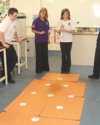 Students observe how many people can become infected from a sneeze.