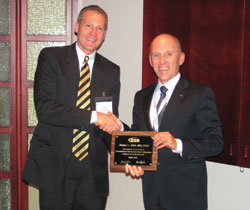 Peter N. Slack presents a plaque to Jorge L. Alió, MD, PhD.