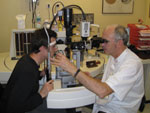 Alain Bron, MD, examines a patient. He said that physicians should treat the overall glaucoma patient and not just the disease.