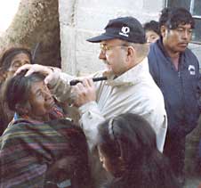 James E. Standefer, MD, examines a patient in Guatemala