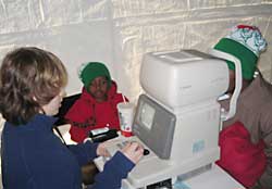 Justin Weiss performing auto-refraction on a patient