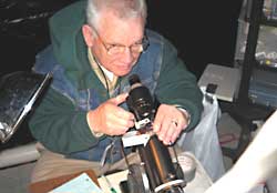 Hubert Thompson performs lensometry on a patient's glasses