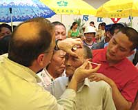 Dr. Farris demonstrates Botulinum toxin injection technique on a Chinese patient