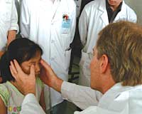 Lloyd Hildebrand, MD, (U.S. faculty) examining a Chinese patient