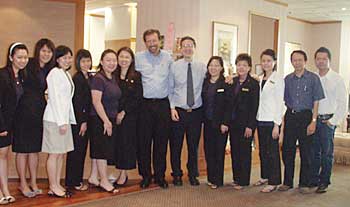 John B. Pinto, center, with Jerry Tan, MD,  his wife, Suan Choo, and their industrious Singapore office staff