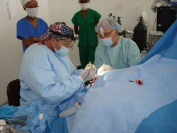 Dr. Slonim, left, performs an orbital exenteration at an operating room converted from a storage building