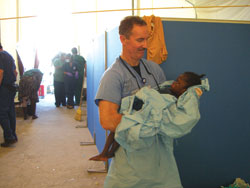 Tom Johnson, MD, takes a moment to comfort an orphan