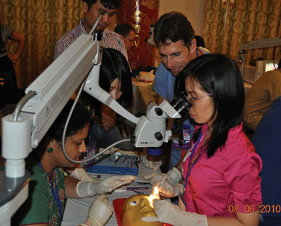 Ghanta Madhavi, MD, and Jeff Rutgard, MD, teach Vietnamese doctors manual small-incision cataract surgery in a wet lab. 