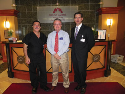 Pictured from left are Adolph V. Lombardi, MD, Bill Sheridan of the Kroger Company, and Keith R. Berend, MD, meet at the center. The Kroger Company donates prescription medications to Operation Joint Implant patients.