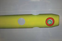 The surgeon manipulates the drill so the green and red circles overlap on the monitor to form a bull’s eye over the locking hole