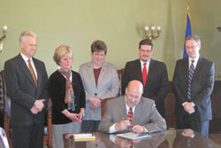 Wis. Governor Jim Doyle signs Assembly Bill 591 into law. 