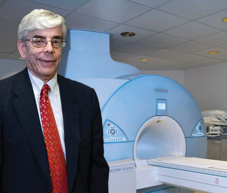 Reichek stands in front of St. Francis Hospital’s MRI system when it was upgraded in 2012. It was the first 32-channel system on Long Island.