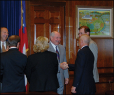 Ajamian shakes Gov. Sonny Perdue’s hand after Perdue signs the Georgia oral medication amplification bill in 2007.