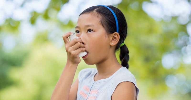 Asian girl with inhaler