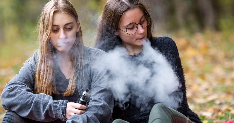 Teenage girls vaping