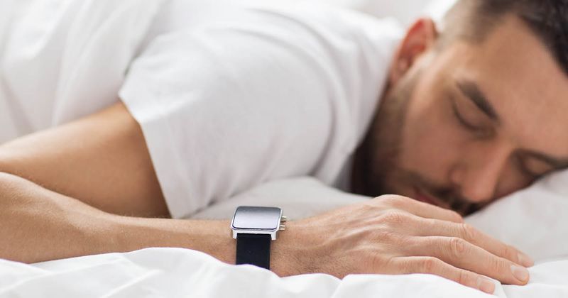 Man sleeping with Apple Watch