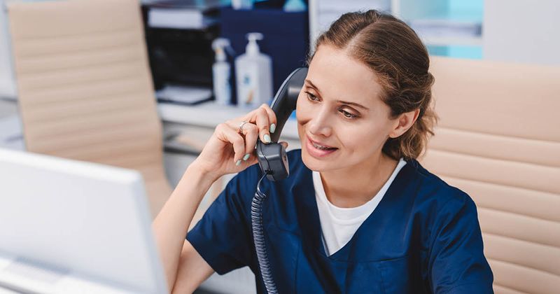 Medical office front desk on phone