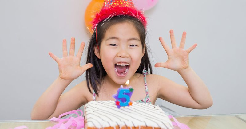 girl and birthday cake