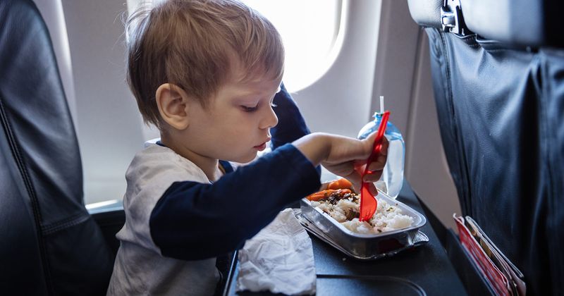 boy eating on a plane