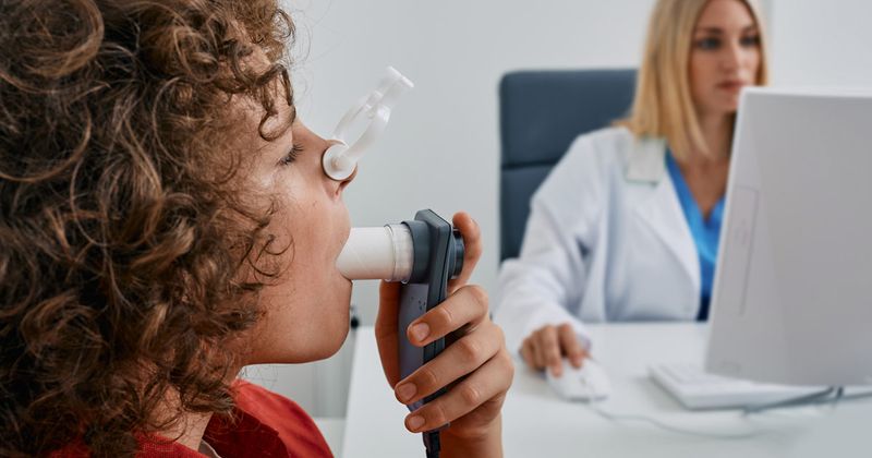 child performing spirometry