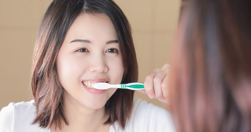 Woman brushing her teeth