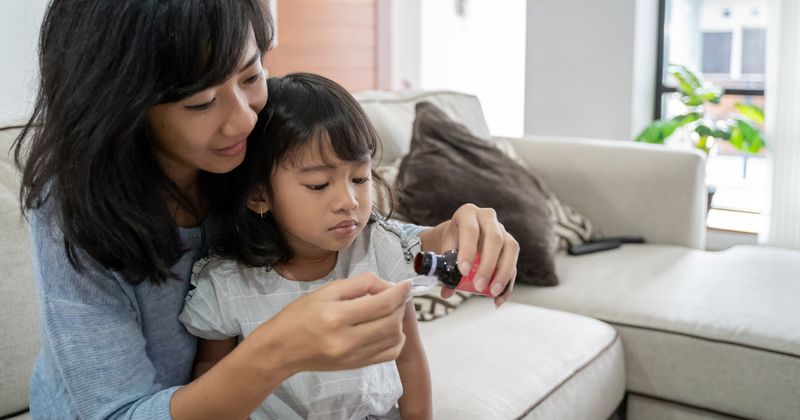 child taking medicine