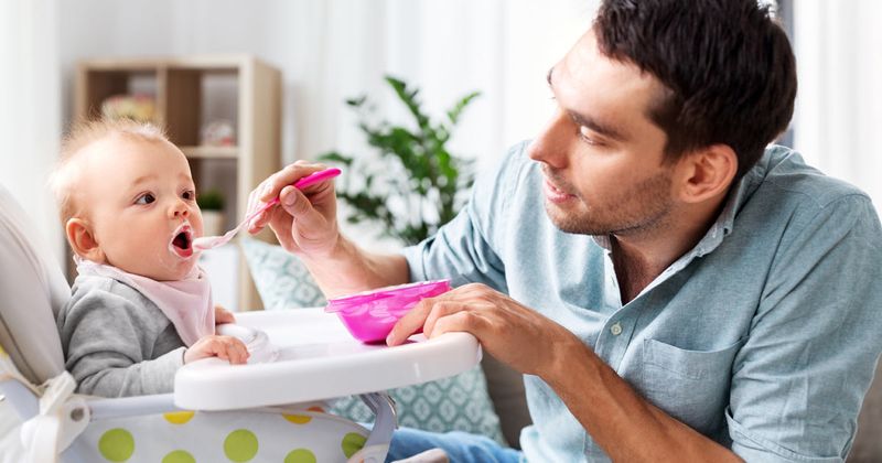 Father feeding a baby