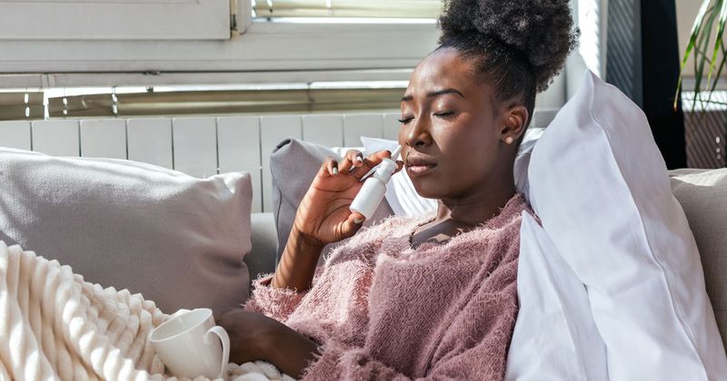 woman using nasal spray