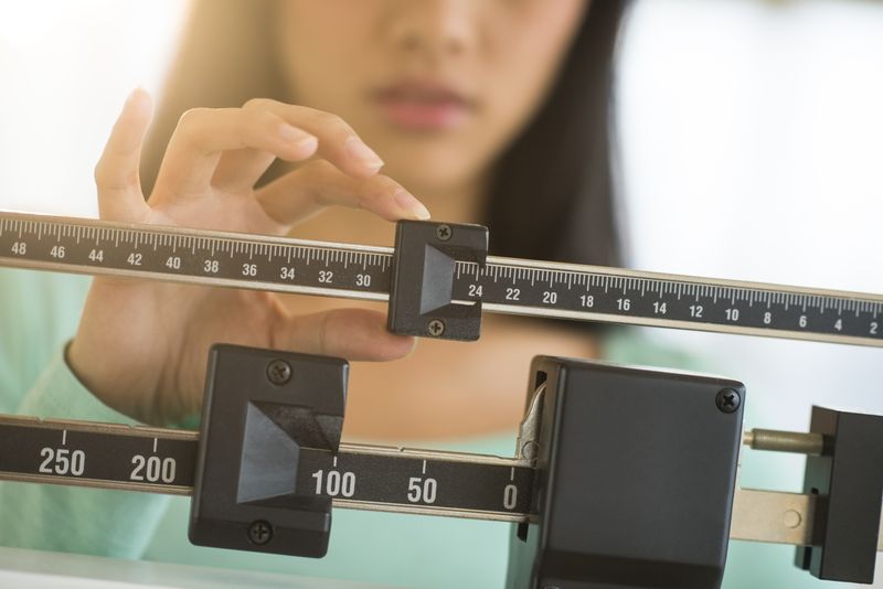 Woman on weight scale 2