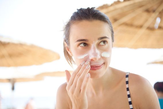 Woman applying sunscreen