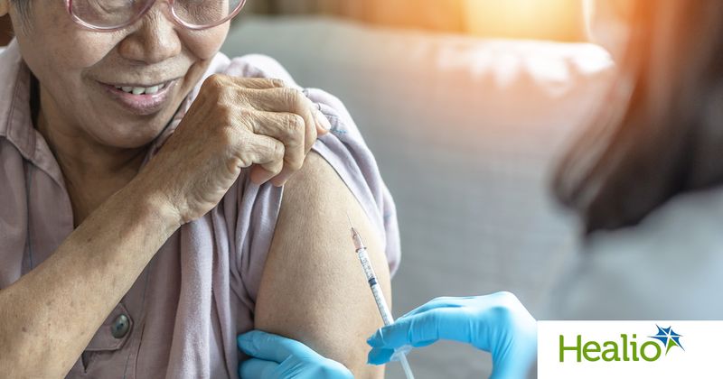 Asian woman receiving vaccine