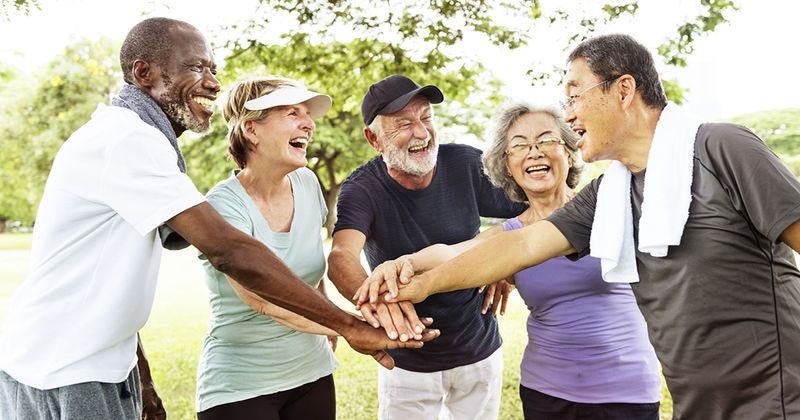 Older adults exercising and supporting each other