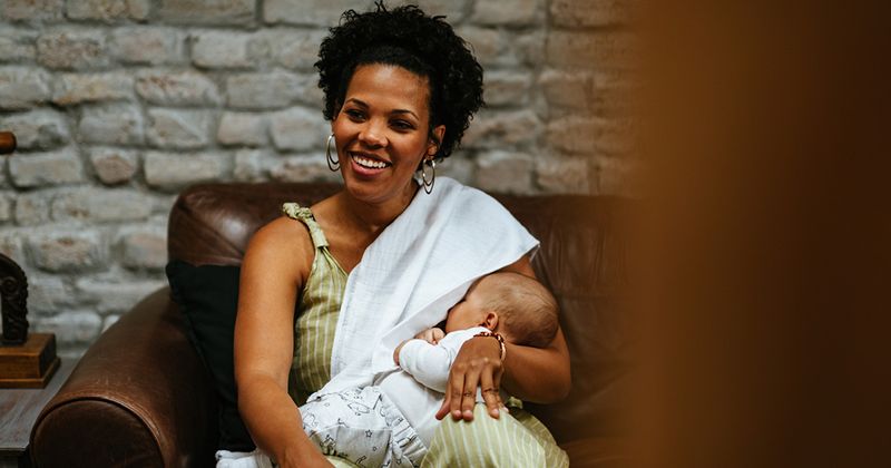 Black woman breastfeeding her child in public