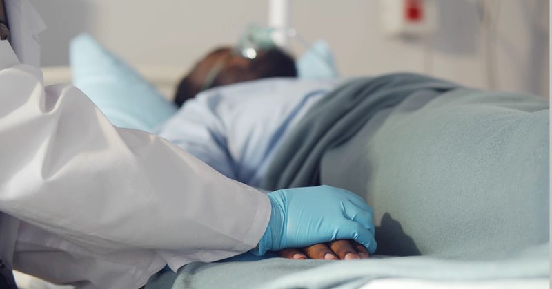 Image of a Black man in a hospital bed