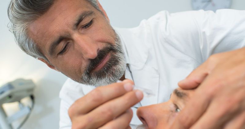 Doctor administering eyedrops