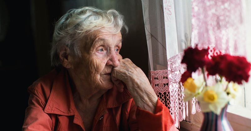 older woman looking out a window