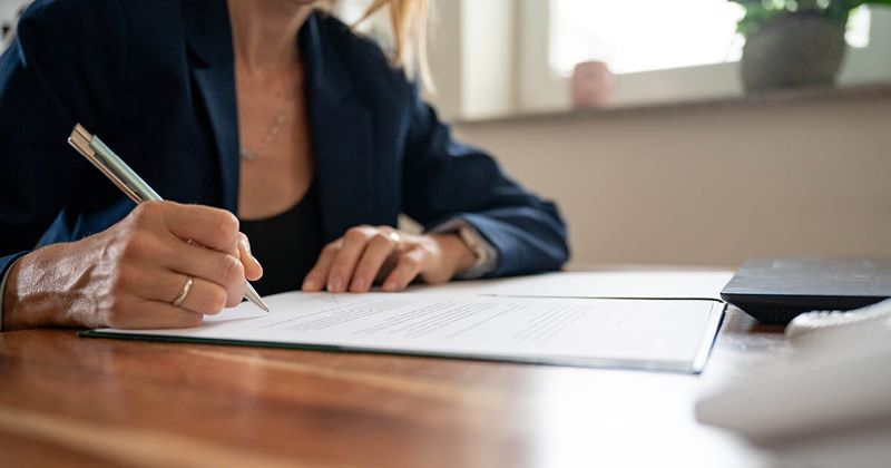 woman signing contract