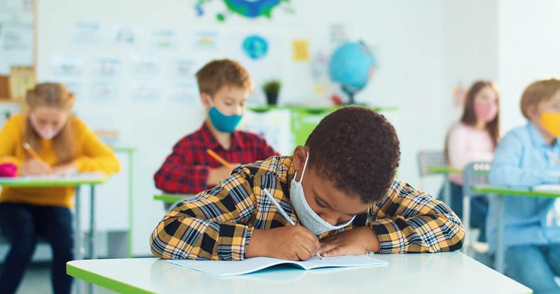 Masked kids in classroom