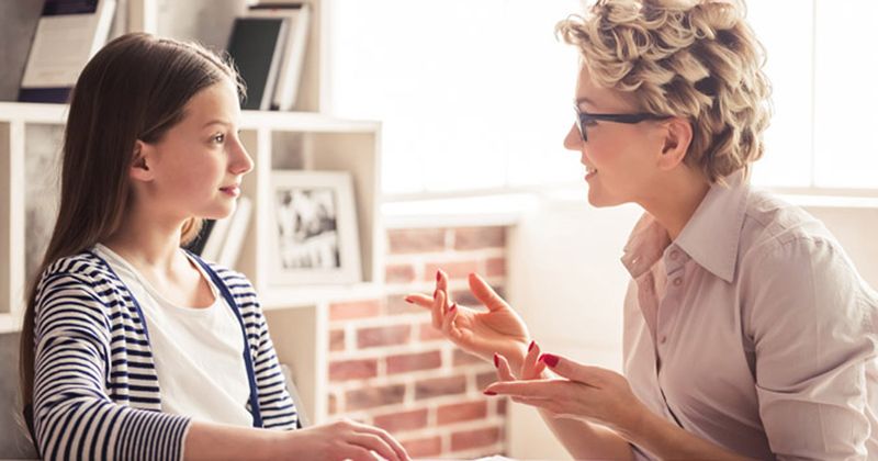 young girl speaking with psychiatrist