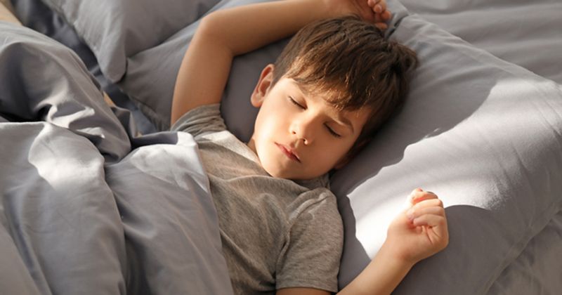 child sleeping in bed