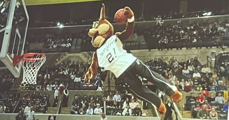 Basketball mascot dunking the ball