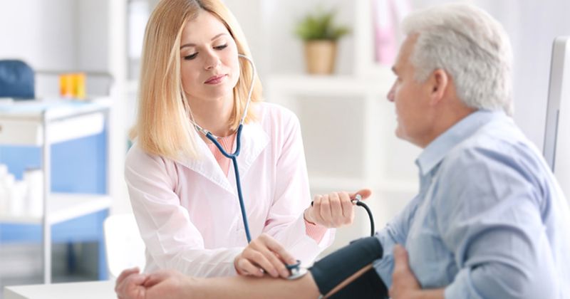 doctor checking blood pressure