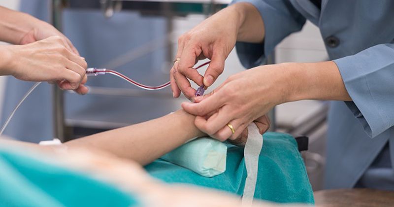 person administering an IV