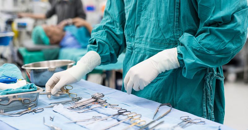 photo of a surgeon's hands and surgical instruments.