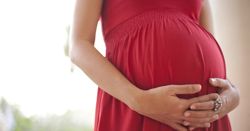 pregnant woman holding baby bump