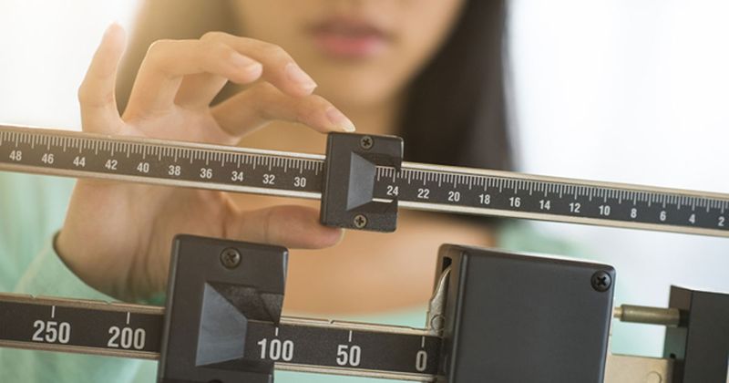 women using weight scale