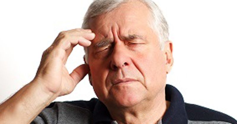 Gray haired man with headache