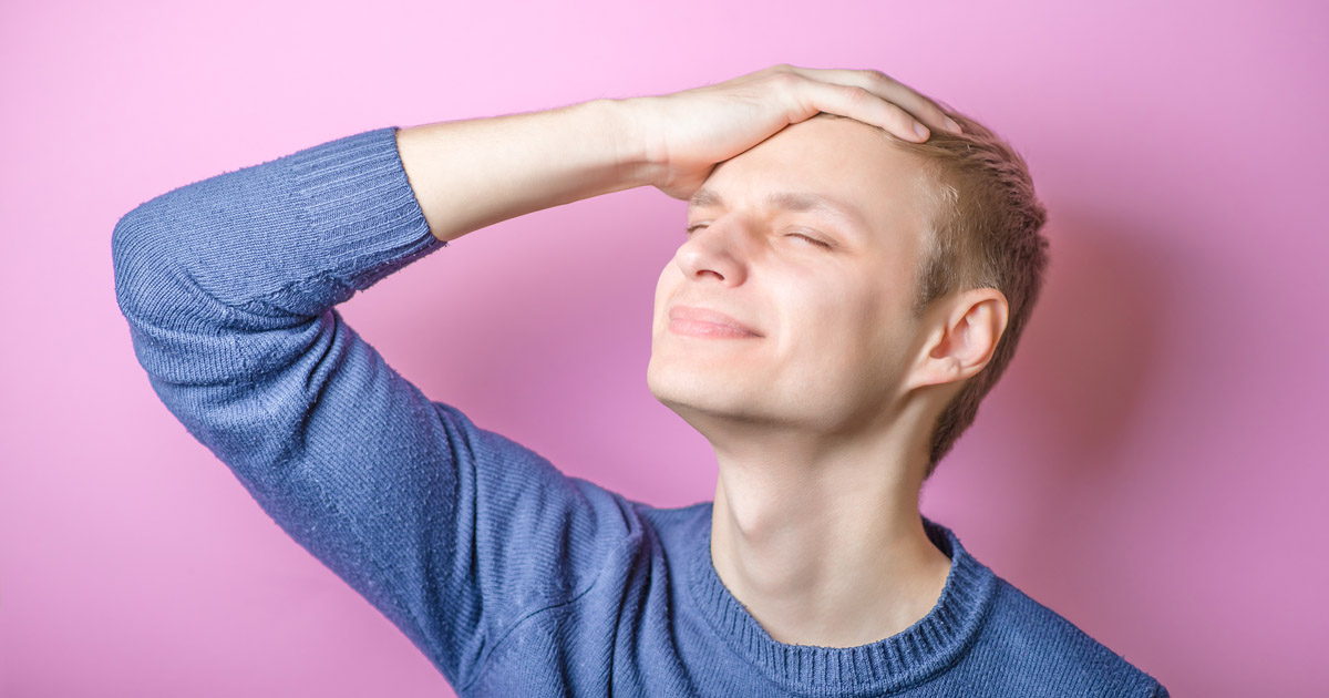 Young caucasian man suffereing from headache